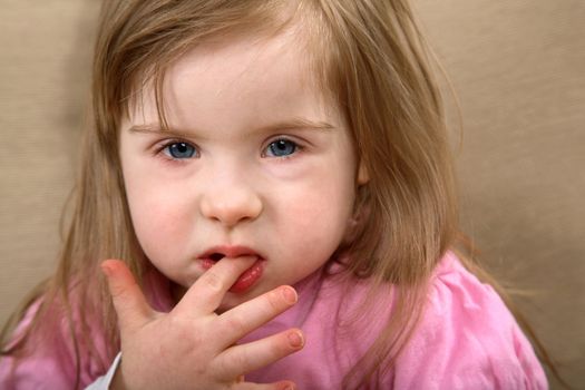 A portrait of a cute girl with Down Syndrome.