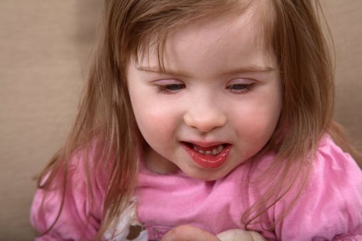 Portrait of little handicapped caucasian girl with Down Syndrome