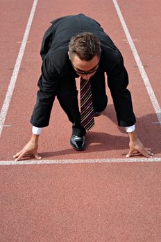 Man running on a track & field complex