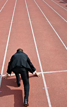 Man running on a track & field complex