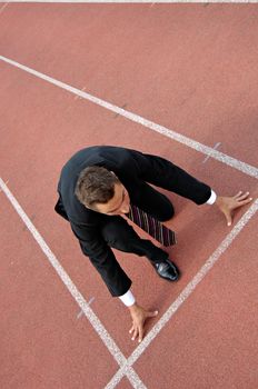 Man running on a track & field complex