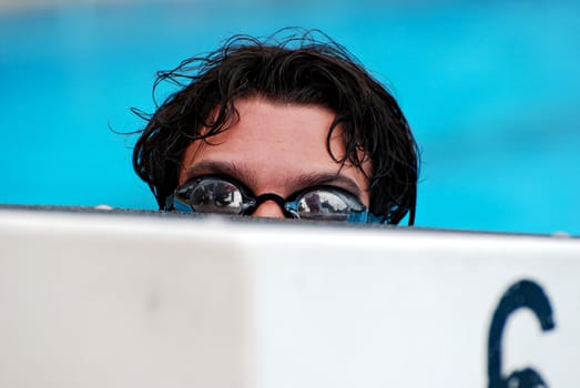 Swimmer behind a starting block