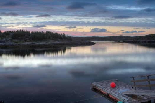 floating fisherman pier in sunset - in a Norwegian fjord.