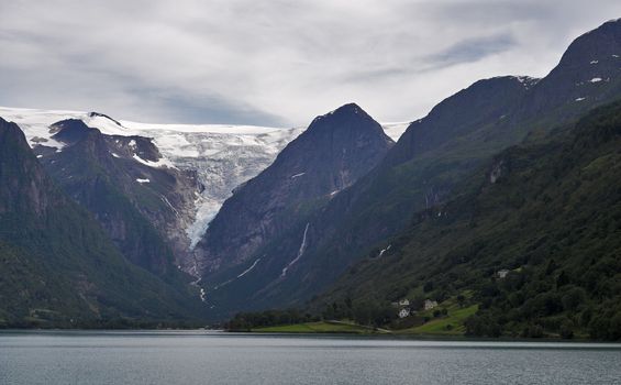 View at mountains and Briksdal glacier above the lake. Norway.