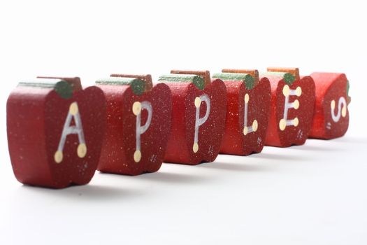 Wooden Apples with letterings spelling "apples."