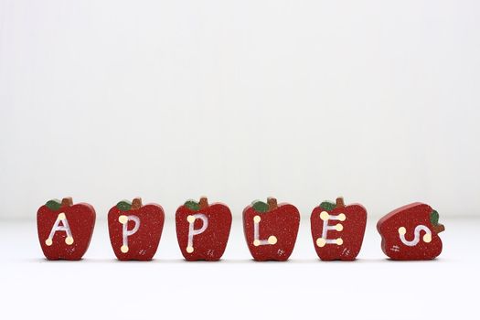 Wooden Apples with letterings spelling "apples."