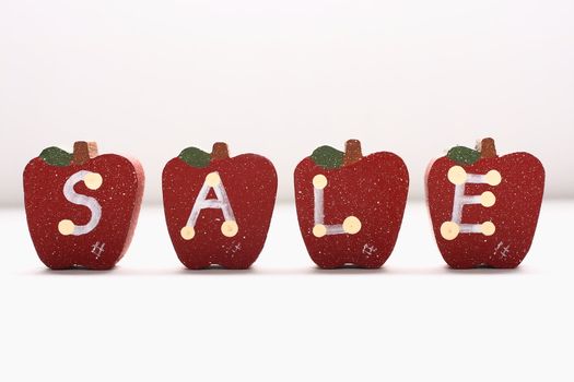 Wooden Apples with letterings spelling "sale."