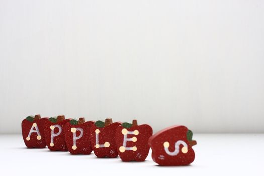 Wooden Apples with letterings spelling "apples."