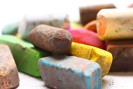 A few used colored chalk pastels on white