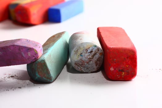 A few used colored chalk pastels on white
