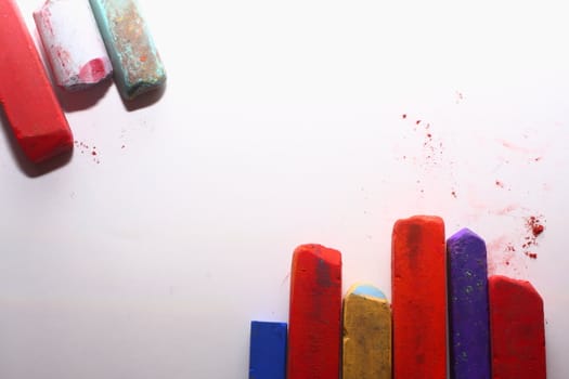 A few used colored chalk pastels on white