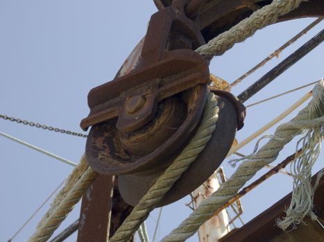 Detail from a rusty ship pulley and ropes 