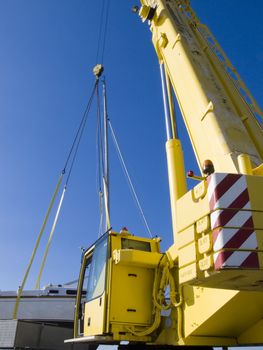 Autocrane unload a sail ship into water