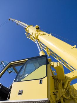 Autocrane unloading against a blue sky