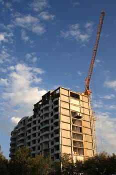 House under construction with a crane/