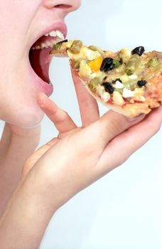 Girl is going to bite off vegetable pizza