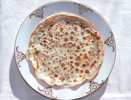 Pancake with herbs on the plate