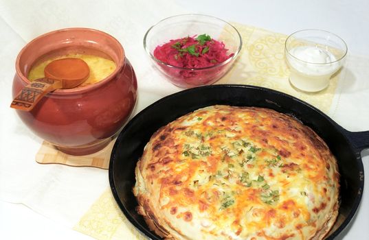 Pancakes and soup in casserole with appetizer