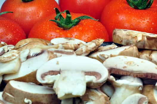 Fresh vegetables: tomatoes and sliced mushrooms