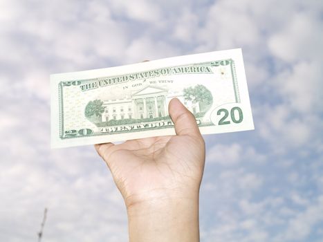 hand holding 20 dollar bill