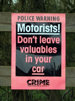 Police sign warning of possible car crime.