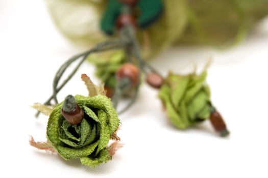 Exotic necklace isolated on white background - green roses and brown wooden beads