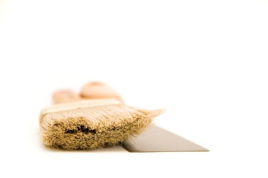 Paintbrush and putty knife isolated on white background