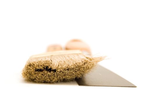 Paintbrush and putty knife isolated on white background