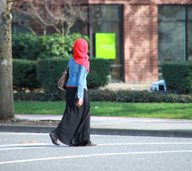 Muslim woman crossing the street.