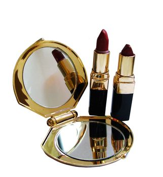 Red lipstick and a mirror with gold trim