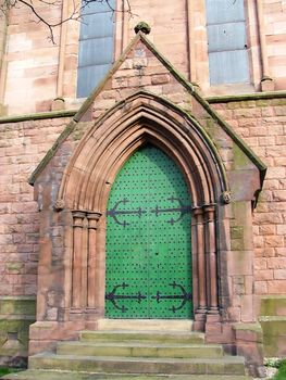 An imposing double door with metal studs