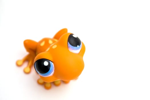 Orange frog toy isolated on white background.