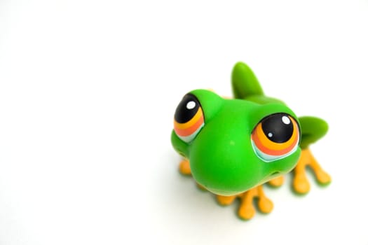 Green frog toy isolated on white background.