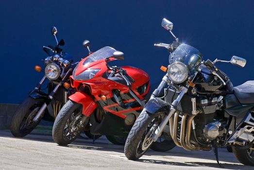 Bright sparkling colorful motocycles, blue background