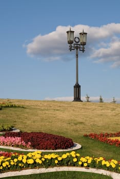 Sunny park with lantern and lawn