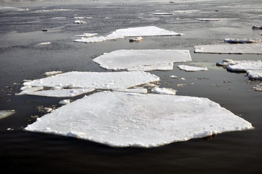 Winter scenery, ice blocks floating on river.