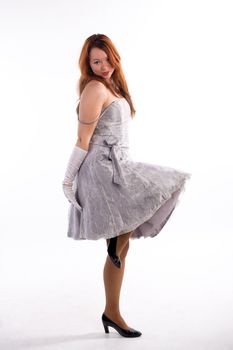 Young girl with white gloves standing on white background
