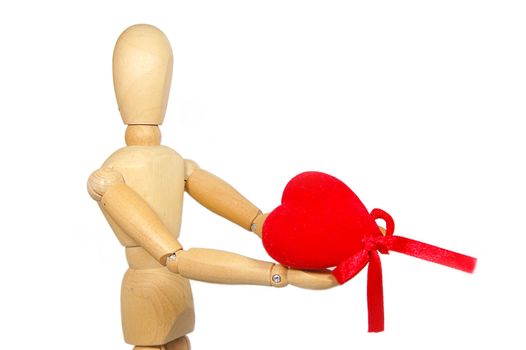 Wooden figurine man holding red fabric heart