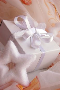 Present white box with silky ribbon in laces