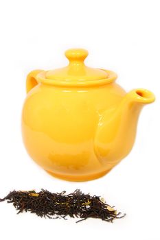 Yellow tea pot with tea leaves isolated on white