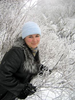 Girl in winter frozen forest