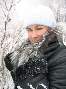 Girl in winter frozen forest