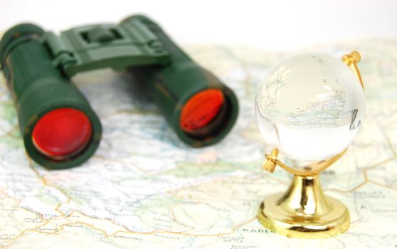 military binoculars, globe and map