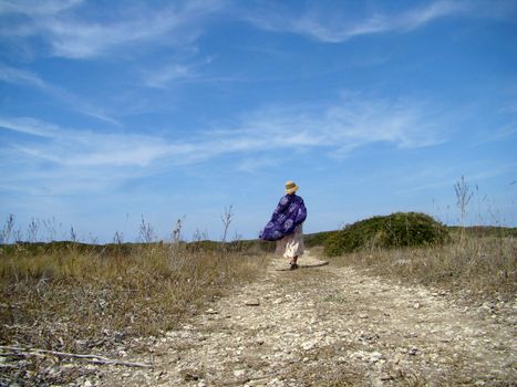 rural landscape with walking woman on the path among fields Tremiti Islands - Apulia - ItalyVI- 2007