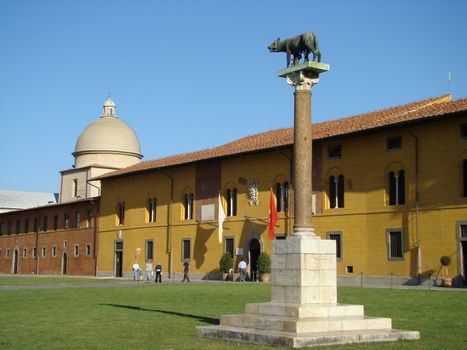 she-woolf monument on Square of Miracles in Pisa in background buildings of Campo SantoTuscanyItaly IX 2007