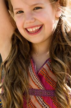 Young girl is smiling while playing on the playground