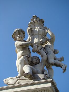 monument on Square of Miracles in Pisa figures of angels are holding coat of the city of Pisa