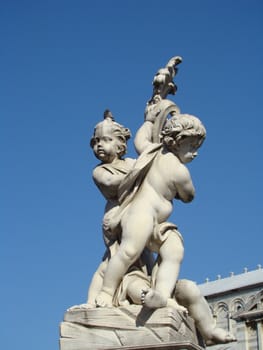 Angels Holding Symbol Of City-
monument on Square of Miracles in Pisa figures of angels are holding coat of 