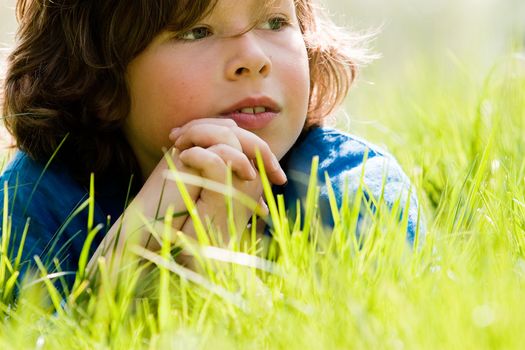 young boy is looking up in the sky