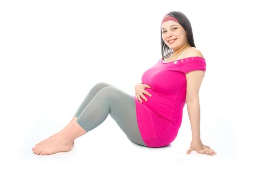 portrait of a happy beautiful pregnant woman sitting on the floor